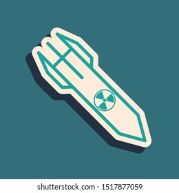 Green Nuclear rocket icon isolated on blue background. Rocket bomb flies down. Long shadow style. Vector Illustration