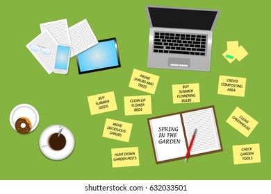 Green office desk top view with supplies, coffee cup and donut. Around the open notepad with the Spring in the garden sign are a yellow notepads with the task you need to do in the spring garden. 