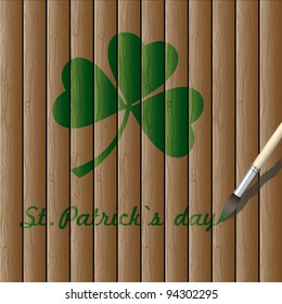 Green paint draw a leaf of clover on wooden background.Vector for St. Patrick's day
