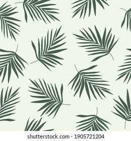 Green palm leaves silhouette on mint background. Seamless tropical patterm for fabrics, textile.Trendy  boho minimalist tropical print