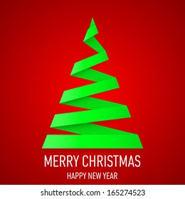 Green paper Christmas tree in origami style on red background. Greeting card.