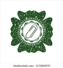 Green paper clip icon inside distress rubber grunge seal