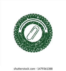 Green paper clip icon inside distress rubber grunge stamp
