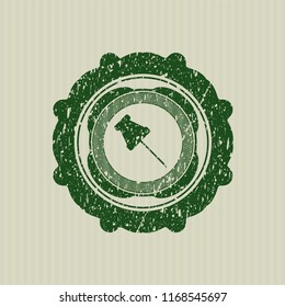 Green paper pin icon inside grunge seal
