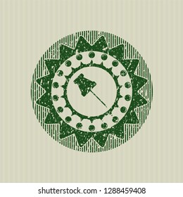 Green paper pin icon inside distressed rubber seal with grunge texture