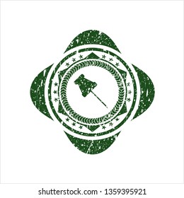 Green paper pin icon inside rubber seal