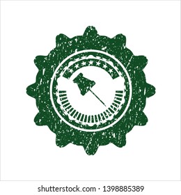 Green paper pin icon inside distressed rubber stamp with grunge texture