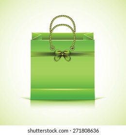 Green paper shopping bag isolated on white background.