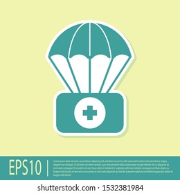 Green Parachute with first aid kit icon isolated on yellow background. Medical insurance.  Vector Illustration