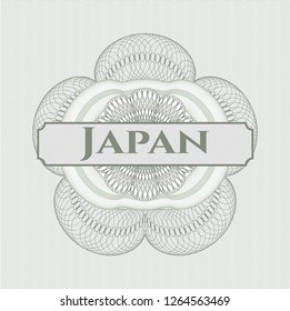 Green passport style rosette with text Japan inside