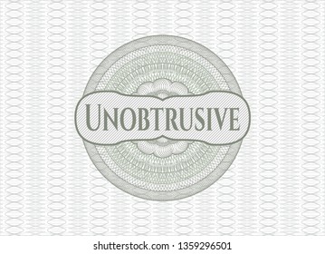 Green passport style rosette with text Unobtrusive inside