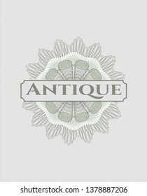 Green passport style rosette with text Antique inside