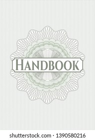 Green passport style rosette with text Handbook inside