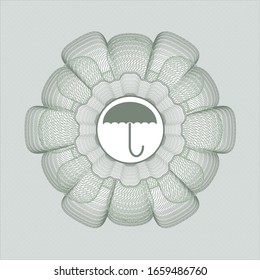 Green passport style rosette with umbrella icon inside