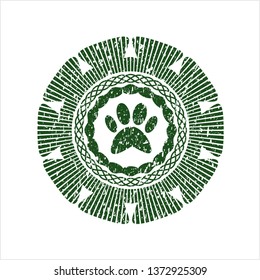 Green paw icon inside distressed rubber grunge stamp