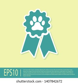 Green Pet award symbol icon isolated on yellow background. Badge with dog or cat paw print and ribbons. Medal for animal. Vector Illustration