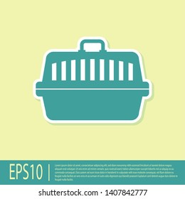 Green Pet carry case icon isolated on yellow background. Carrier for animals, dog and cat. Container for animals. Animal transport box. Vector Illustration