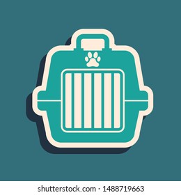 Green Pet carry case icon isolated on blue background. Carrier for animals, dog and cat. Container for animals. Animal transport box. Long shadow style. Vector Illustration