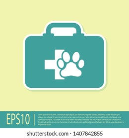 Green Pet first aid kit icon isolated on yellow background. Dog or cat paw print. Clinic box. Vector Illustration