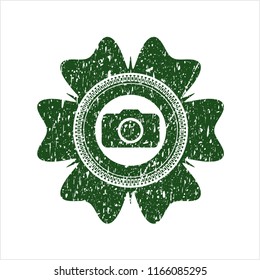 Green photo camera icon inside rubber grunge texture seal