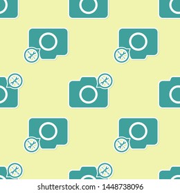 Green Photo camera with screwdriver and wrench icon isolated seamless pattern on yellow background. Adjusting, service, setting, maintenance, repair, fixing.  Vector Illustration