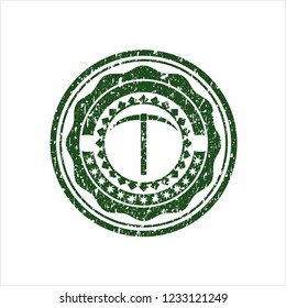 Green pickaxe icon inside distress rubber seal with grunge texture