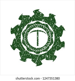 Green pickaxe icon inside distressed rubber grunge stamp