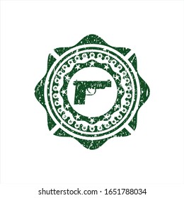 Icono de pistola verde dentro de la textura de caucho