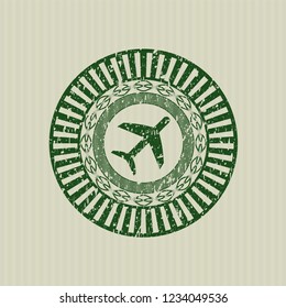 Green plane icon inside distress rubber seal