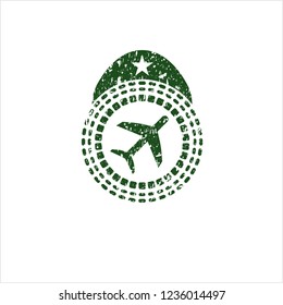 Green plane icon inside distress rubber seal with grunge texture