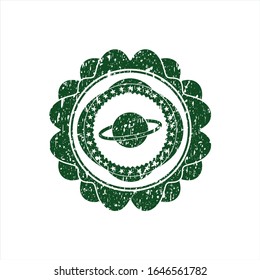 Planeta verde, icono de saturn dentro de la textura de caucho en peligro