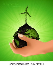 green planet with a windmill grass. the concept of clean energy