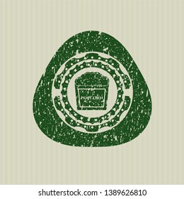 Green popcorn icon inside rubber seal