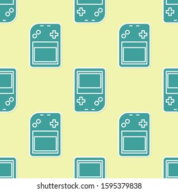 Green Portable video game console icon isolated seamless pattern on yellow background. Gamepad sign. Gaming concept.  Vector Illustration