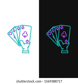 Green and purple line Hand holding playing cards icon isolated on white and black background. Casino game design.  Vector Illustration
