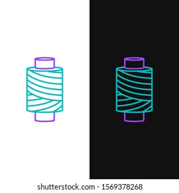 Green and purple line Sewing thread on spool icon isolated on white and black background. Yarn spool. Thread bobbin.  Vector Illustration