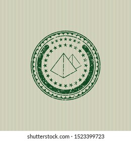 Green pyramids icon inside grunge stamp