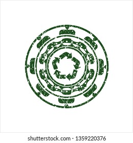 Green recycle icon inside distressed rubber stamp with grunge texture