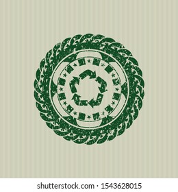 Green recycle icon inside distressed rubber stamp