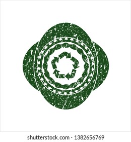 Green recycle icon inside grunge seal
