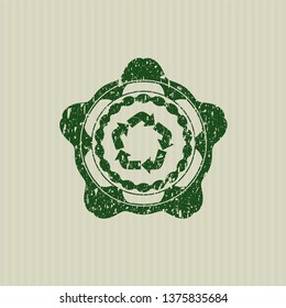 Green recycle icon inside rubber texture