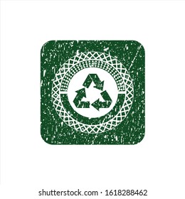 Green recycle icon inside rubber grunge stamp