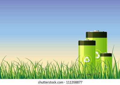 Green recycleable batteries in the open green field.