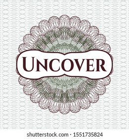 Green and Red passport rosette with text Uncover inside