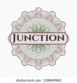 Green and Red passport style rosette with text Junction inside