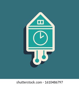 Green Retro wall watch icon isolated on blue background. Cuckoo clock sign. Antique pendulum clock. Long shadow style. Vector Illustration
