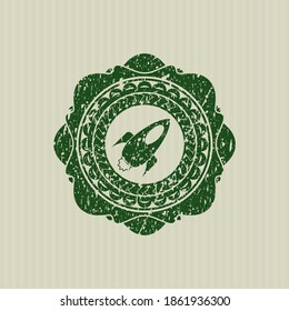 Green rocket icon inside distressed grunge seal. 