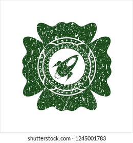 Green rocket icon inside rubber grunge seal