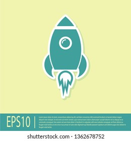 Green Rocket ship with fire icon isolated on yellow background. Space travel. Vector Illustration