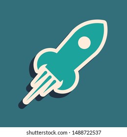 Green Rocket ship with fire icon isolated on blue background. Space travel. Long shadow style. Vector Illustration
